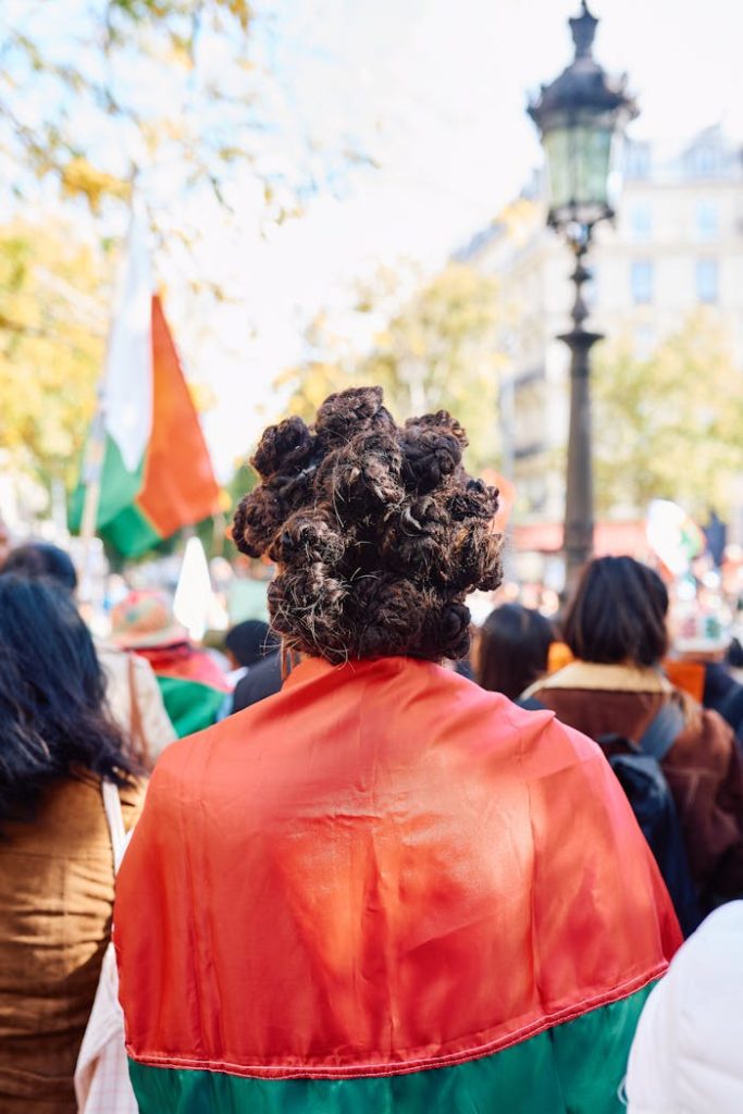 A peaceful demonstration in Paris featuring people with colorful flags, creating a vibrant and dynamic scene.